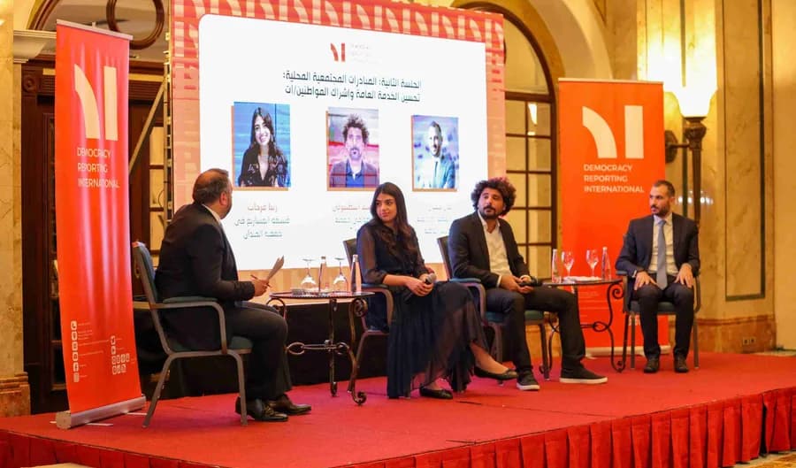Panel discussion on a DRI stage, from the Beirut office card