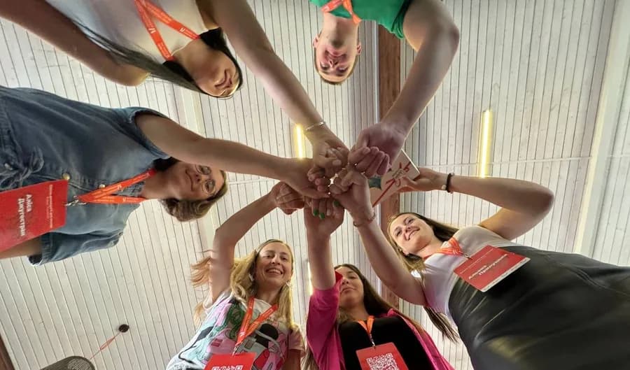 Participants joining hands, from the Kyiv office card