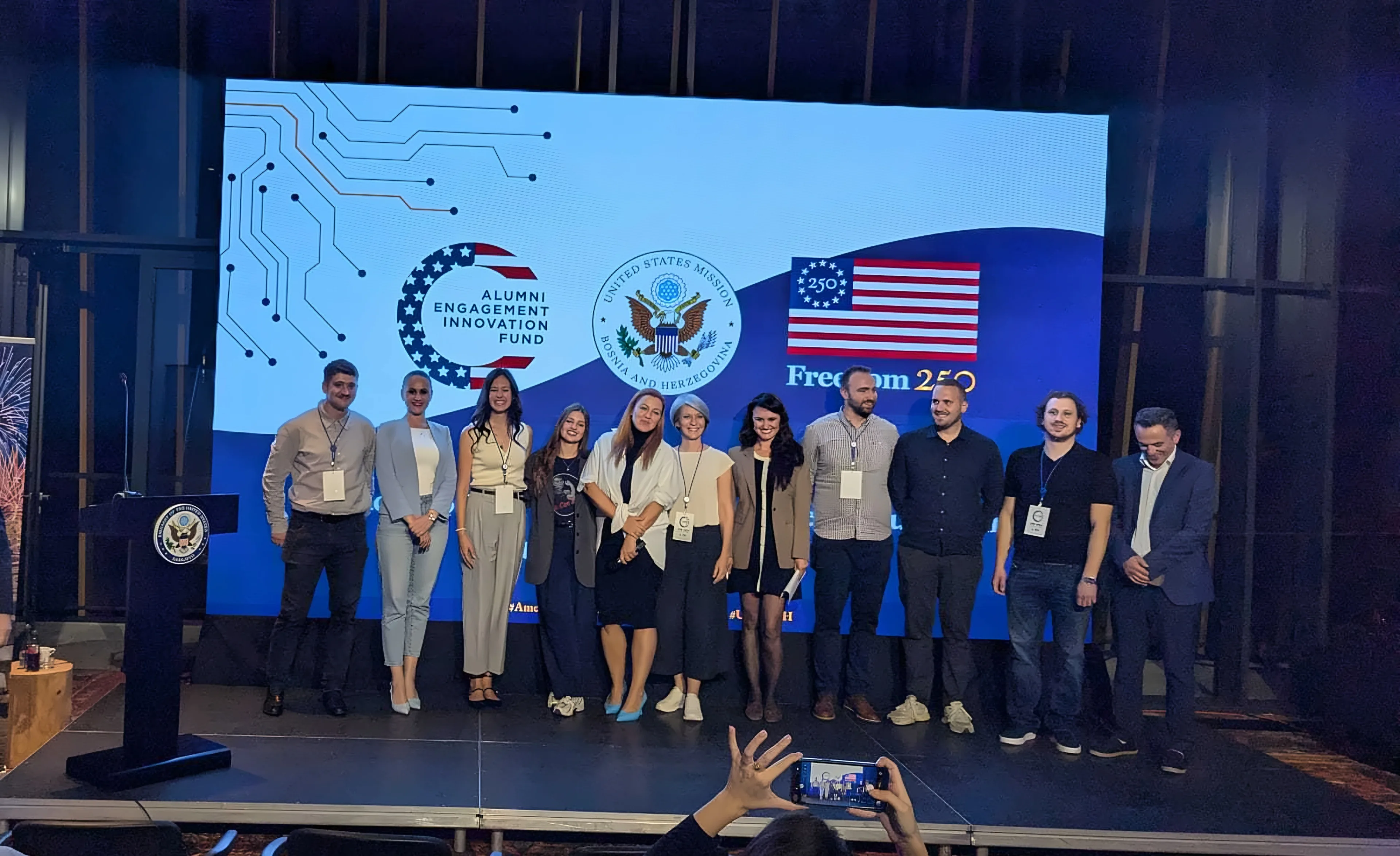 Participants on stage at the AEIF 2026 Alumni Summit, in front of the AEIF and Freedom 250 logos