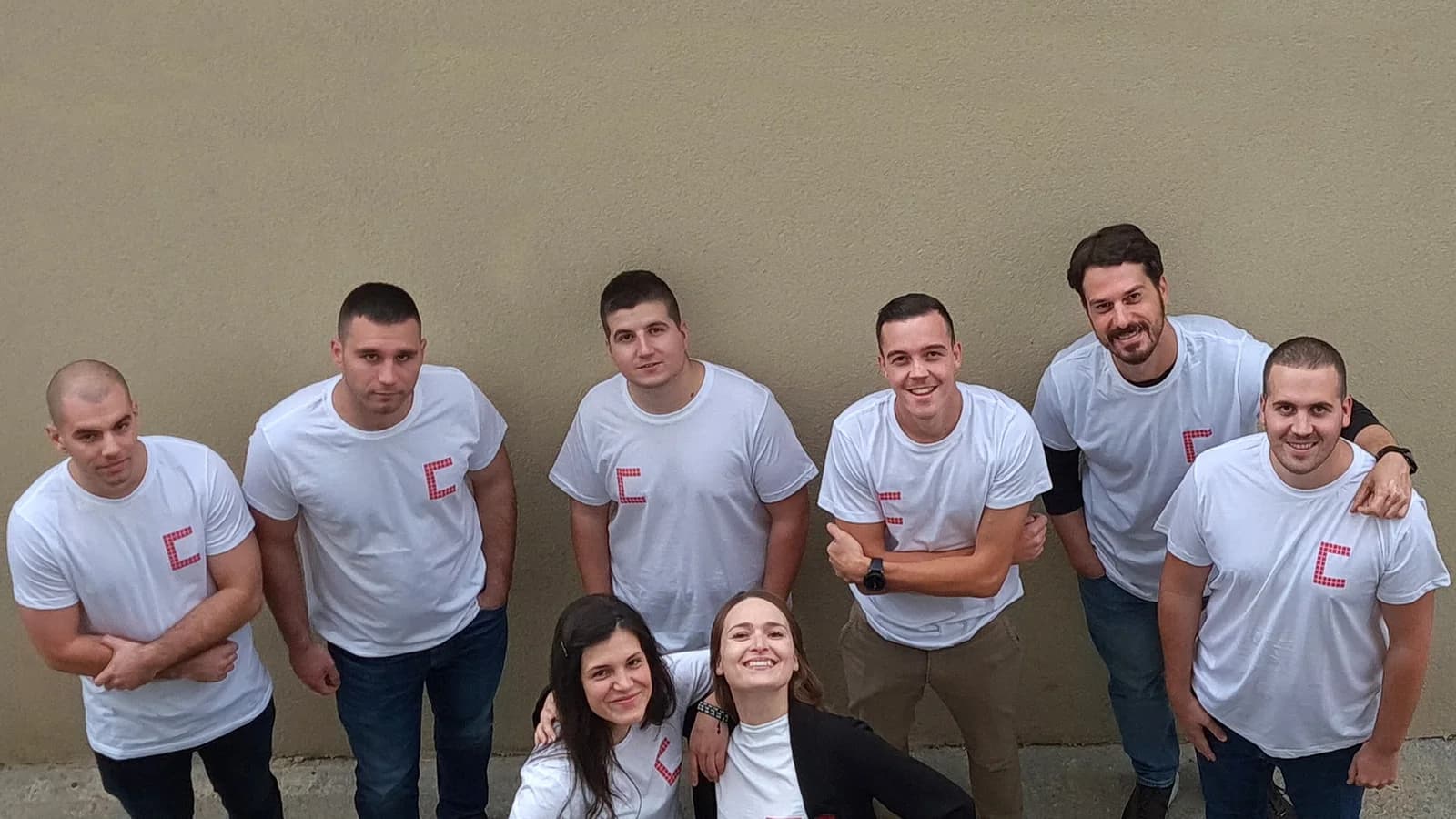 The Codepixel team in branded shirts, photographed from above