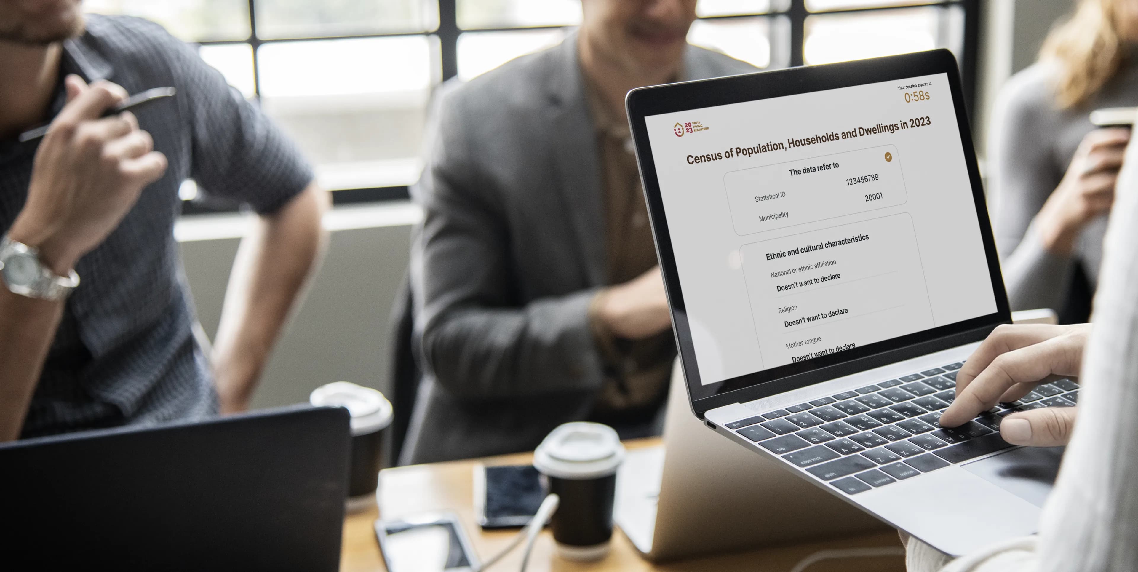 A team around a laptop showing the census lookup form