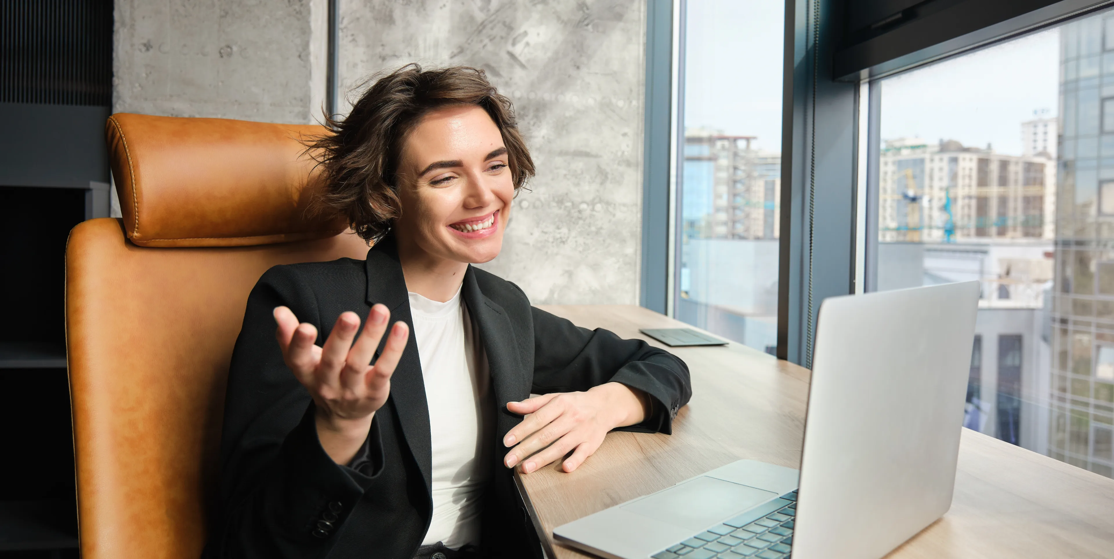 A professional in a coaching session at her laptop