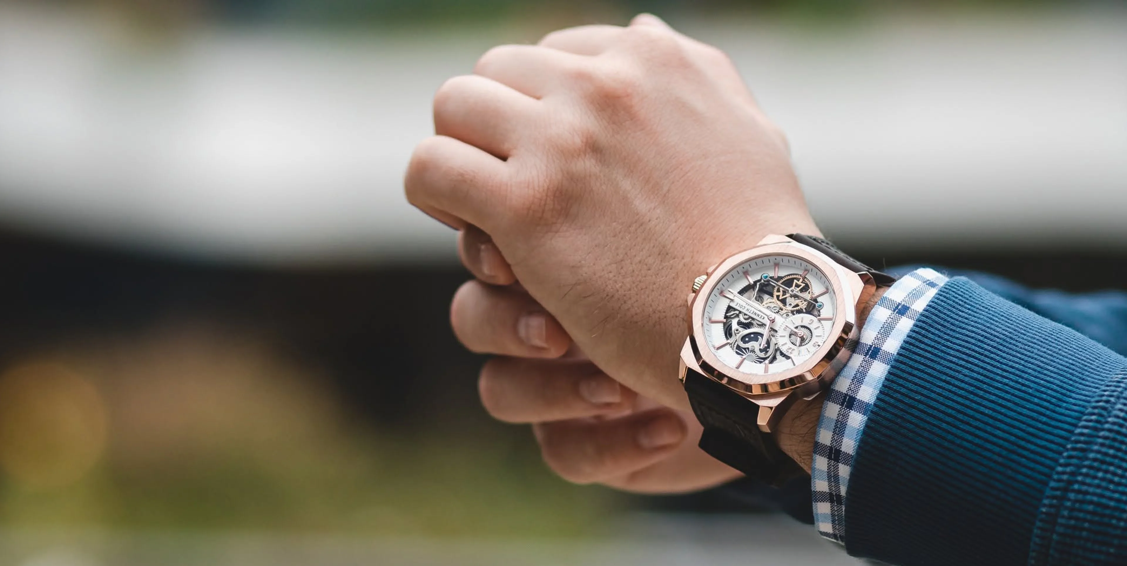 A Kenneth Cole automatic watch worn on a wrist